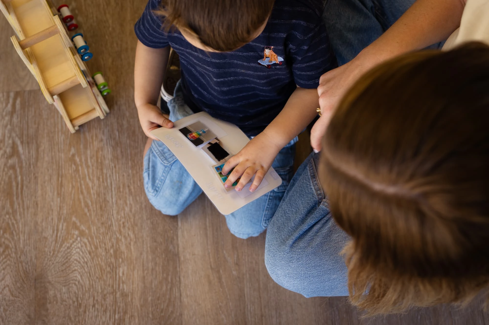 Speech Pathologist supporting a child during a therapy session