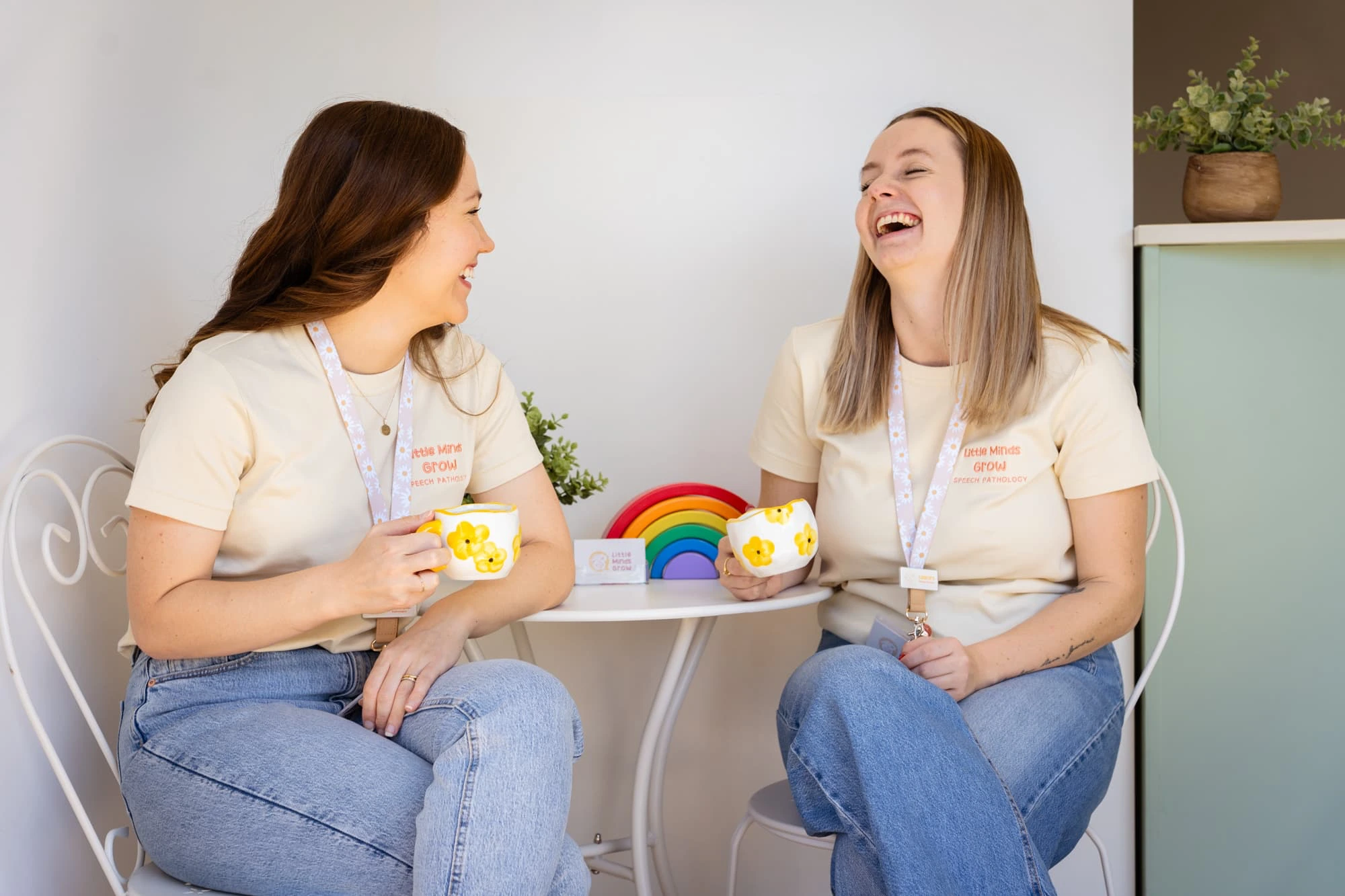 Speech pathologists laughing together at clinic