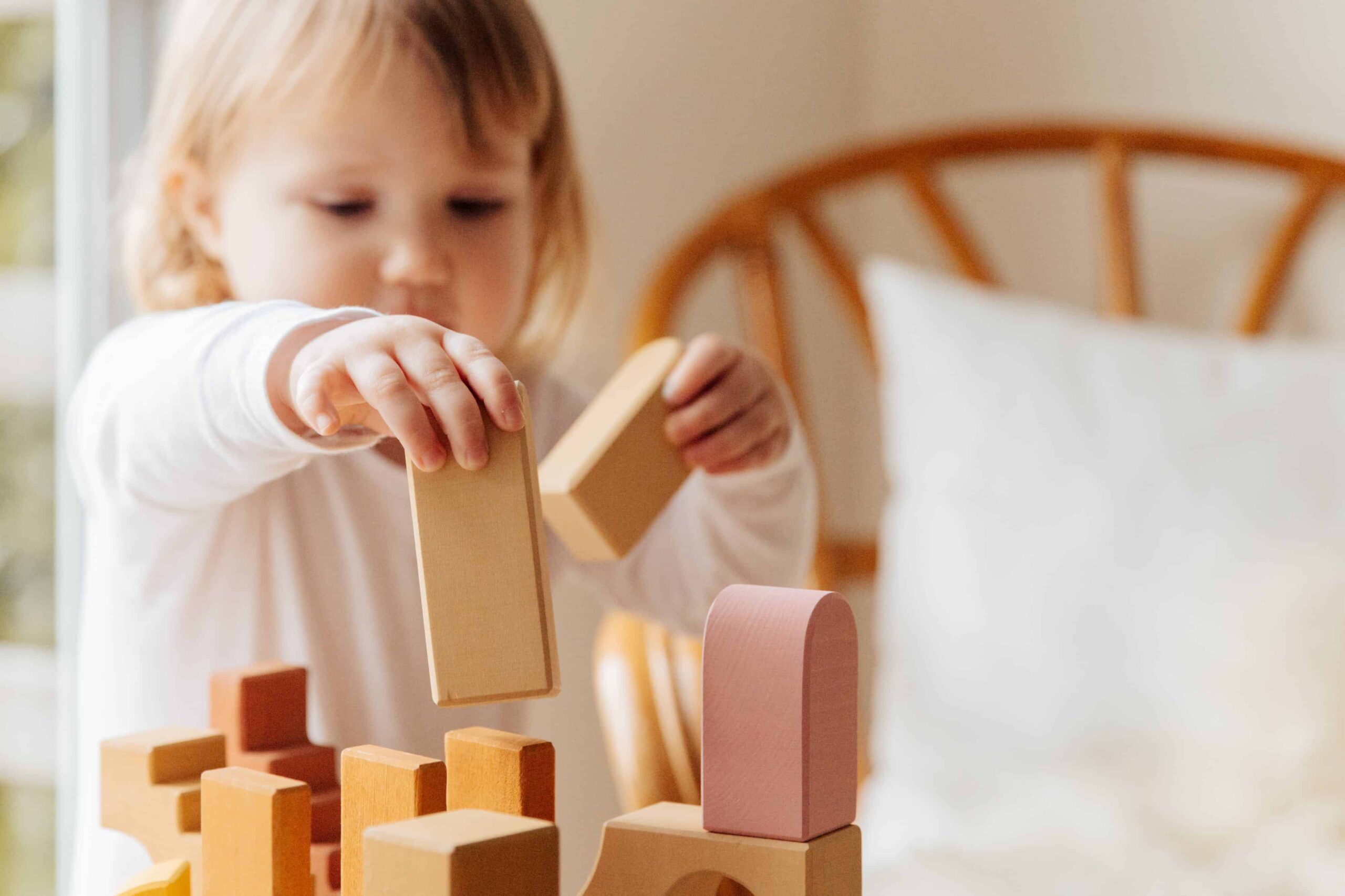 A child playing with blocks during speech therapy for kids on the Gold Coast